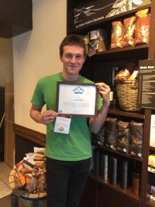 Towson student Jacob Badin proudly displays his Partner of the Quarter plaque. 